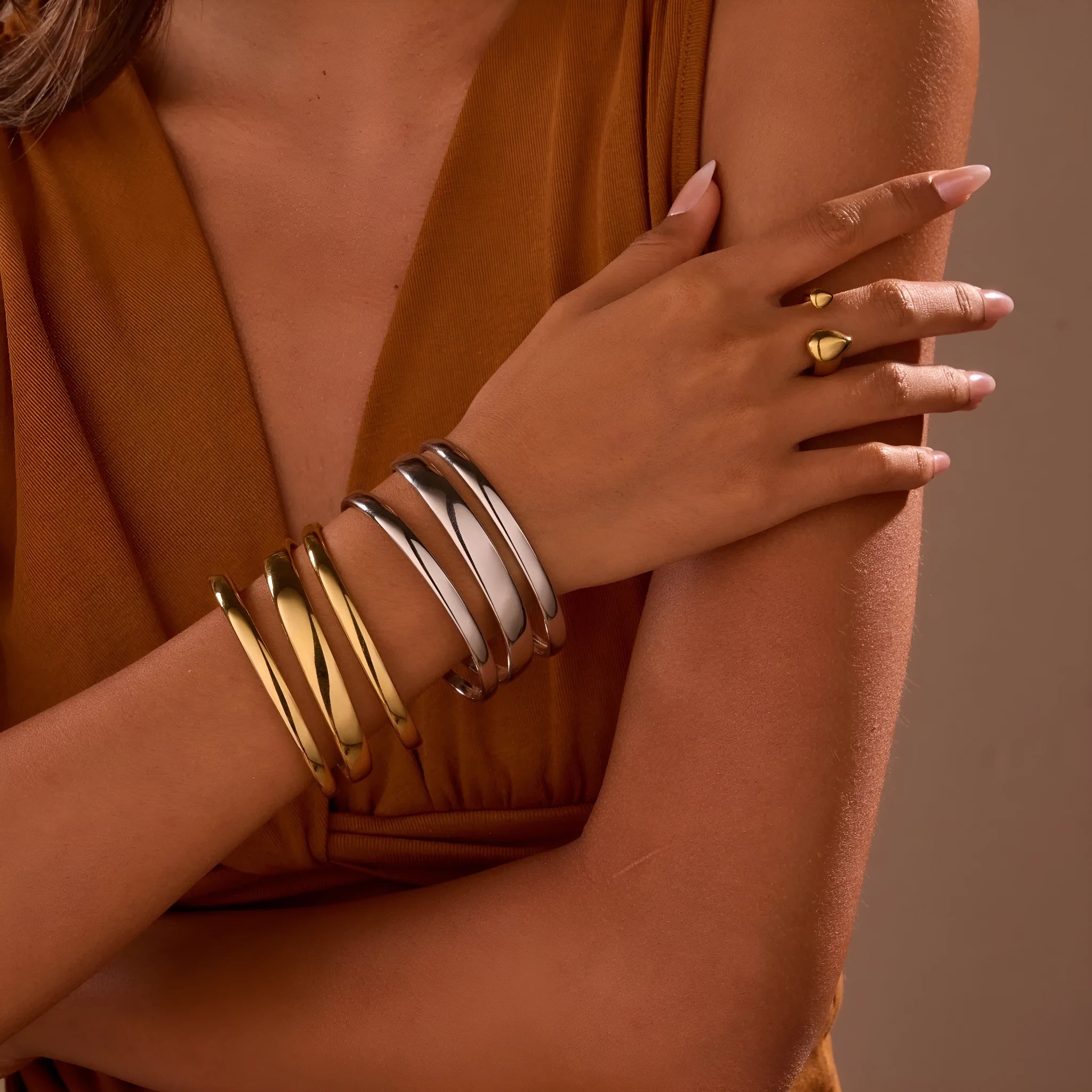 A geometric line design bracelet for women on wrist, shown in stainless steel with a simple opening clasp.