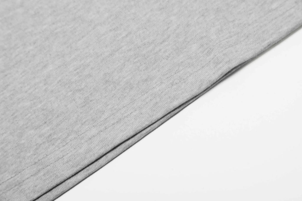 A man's loose-fit cotton pullover hoodie in a simple retro style, shown in grey colour.