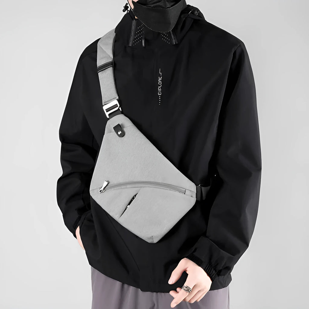 Men's black Oxford cloth chest bag worn on left shoulder with letter accent detail