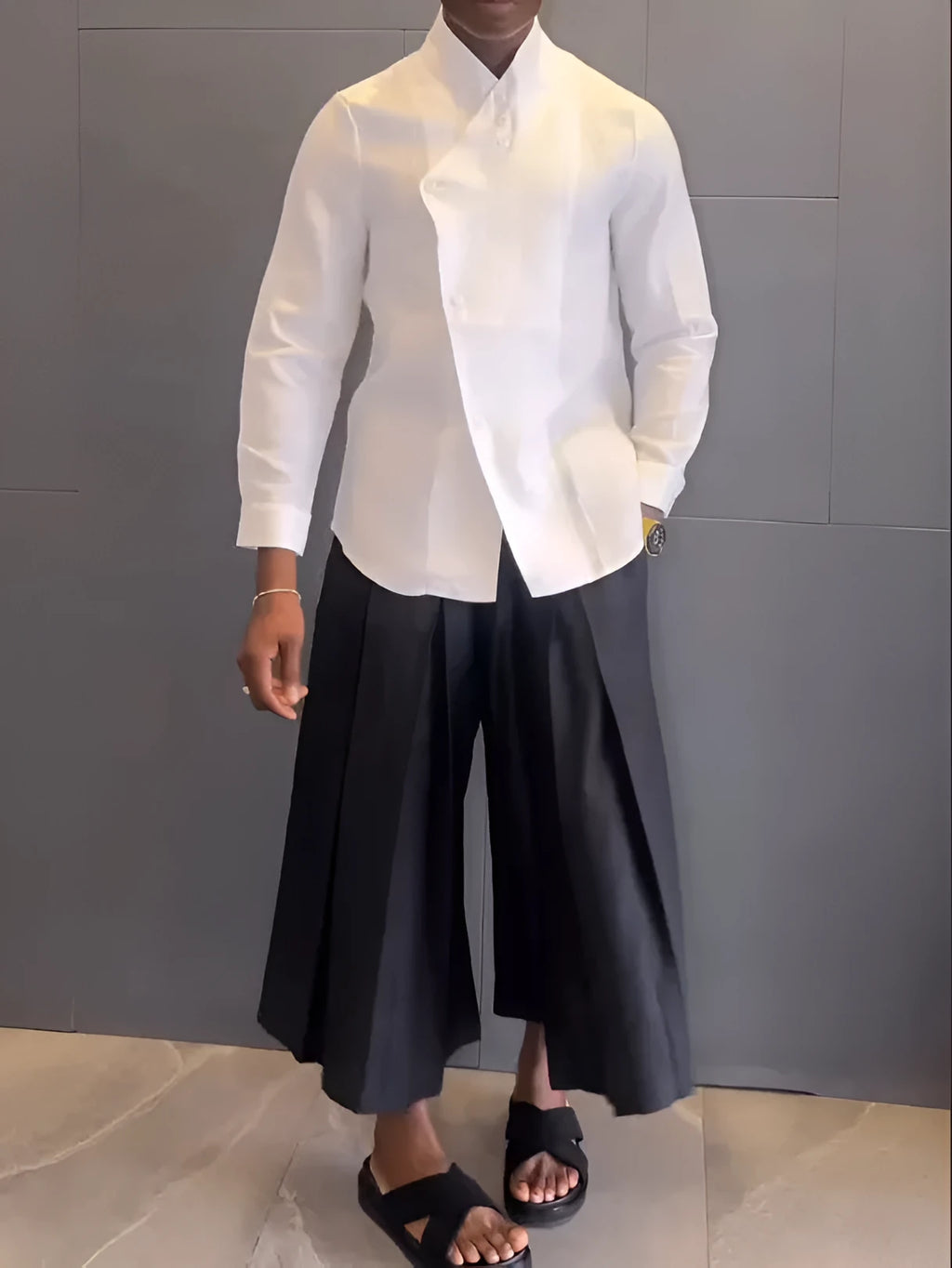 White asymmetric long sleeve shirt paired with black pleated pants in a women's casual two-piece set.