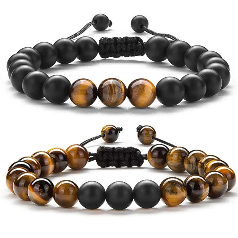 Matte black agate couple bracelets with geometric beads on wrist.