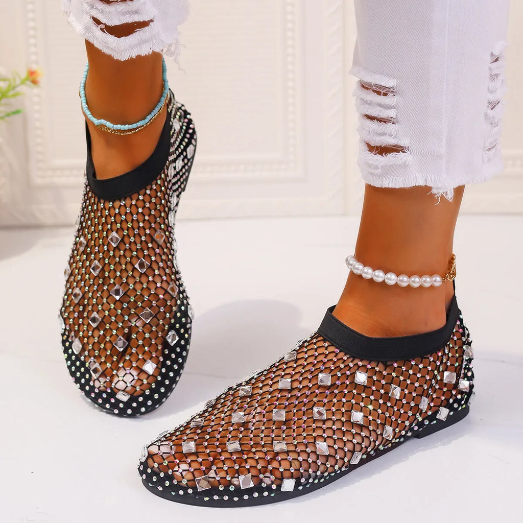 Colourful rhinestone detail on the mesh upper of women's white flat sandals with a round toe.