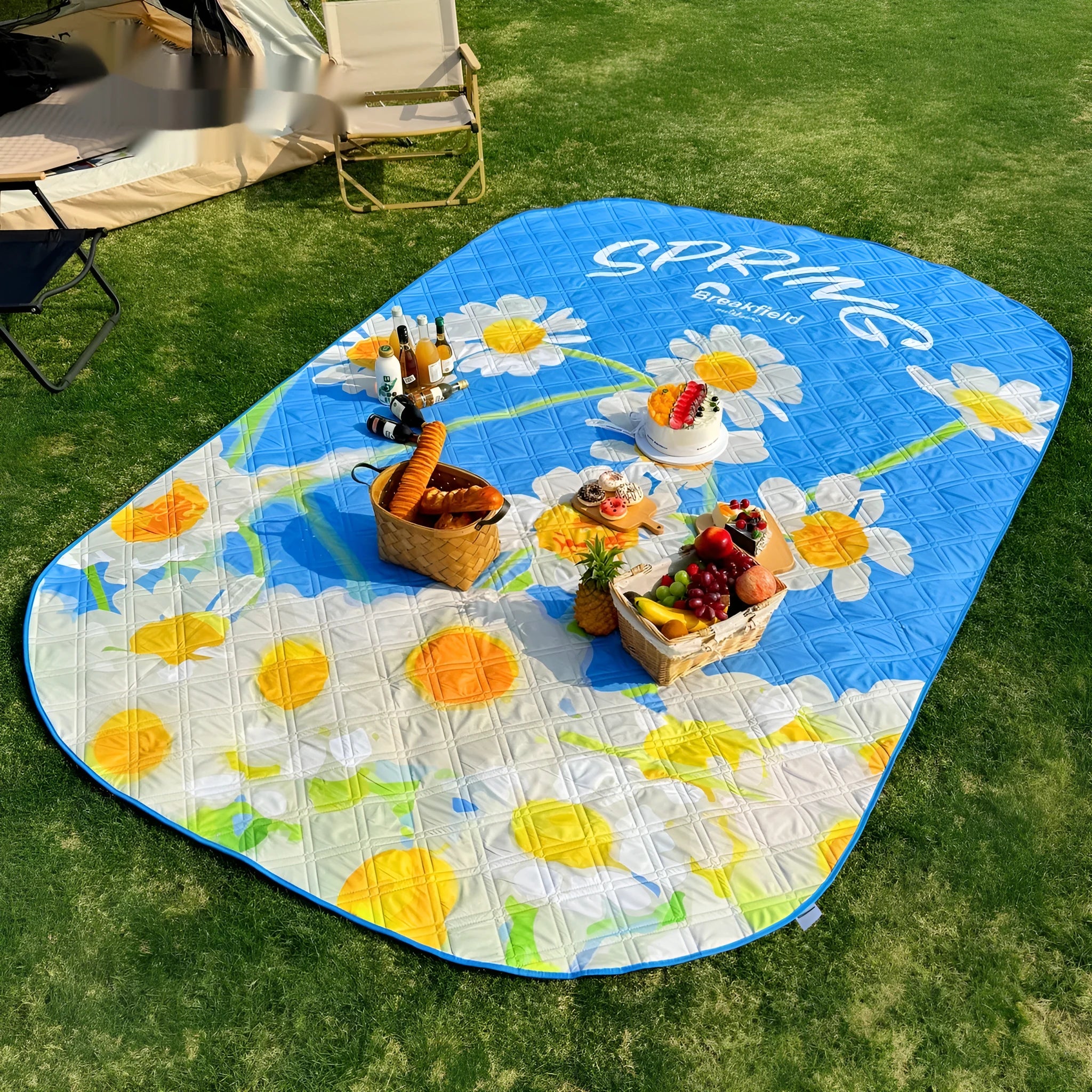 Waterproof thickened picnic mat in a seasonal colour, laid out flat on grass.