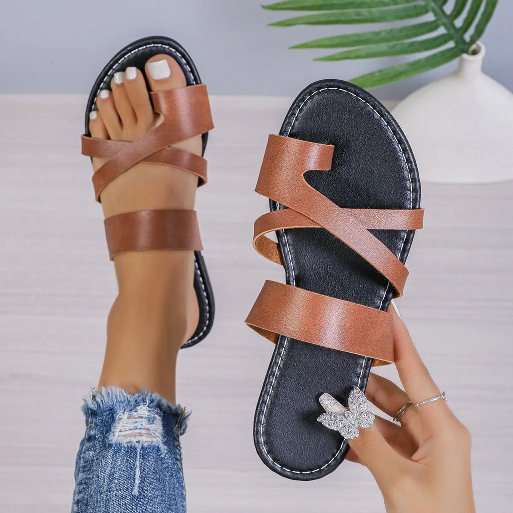 Adult beach slippers with hollow-out design in black, brown, and wine red colours showing rubber sole