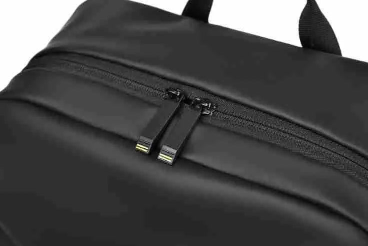 Men's large capacity waterproof backpack in black colour showing PU leather construction and computer bag accommodation