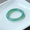 Natural agate wide tyre bracelet shown in multiple colour options on a wrist, demonstrating its substantial band width.