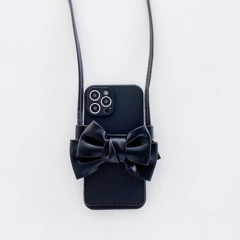 Ladies crossbody bag phone case in black with bow and strap showing iPhone in case front view