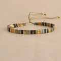 Geometric glass and coloured glaze beaded bracelet with a pull clasp in milky white colour.