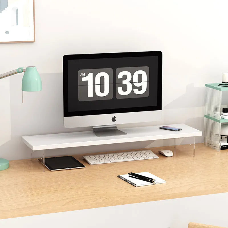 Black computer riser with acrylic legs on desk under monitor