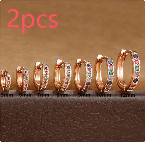 Circle-shaped zircon stud earrings in gold, rose gold, or silver colour on a white background.