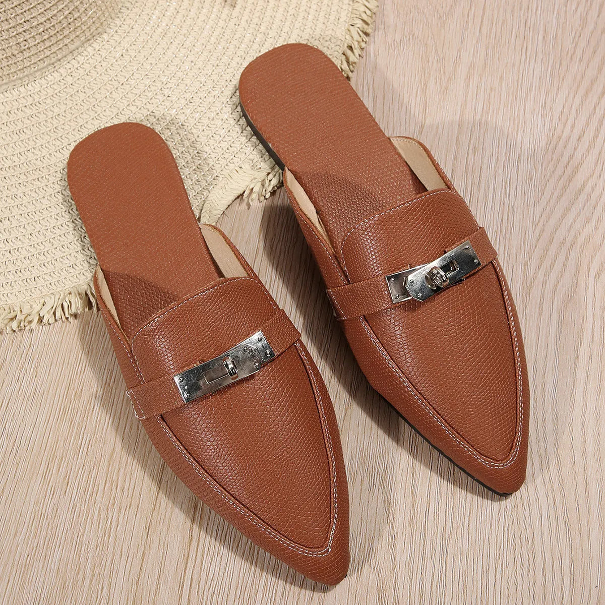 Light brown women's pointed-toe low heel semi-slippers with a rubber sole.