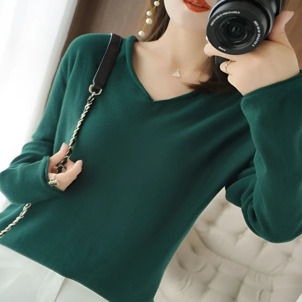 Women's grey V-neck long sleeve knitwear pullover on a hanger