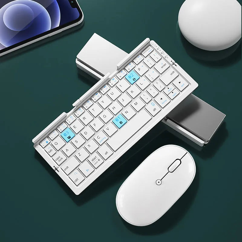 Silver folding Bluetooth keyboard open with phone standing in integrated holder