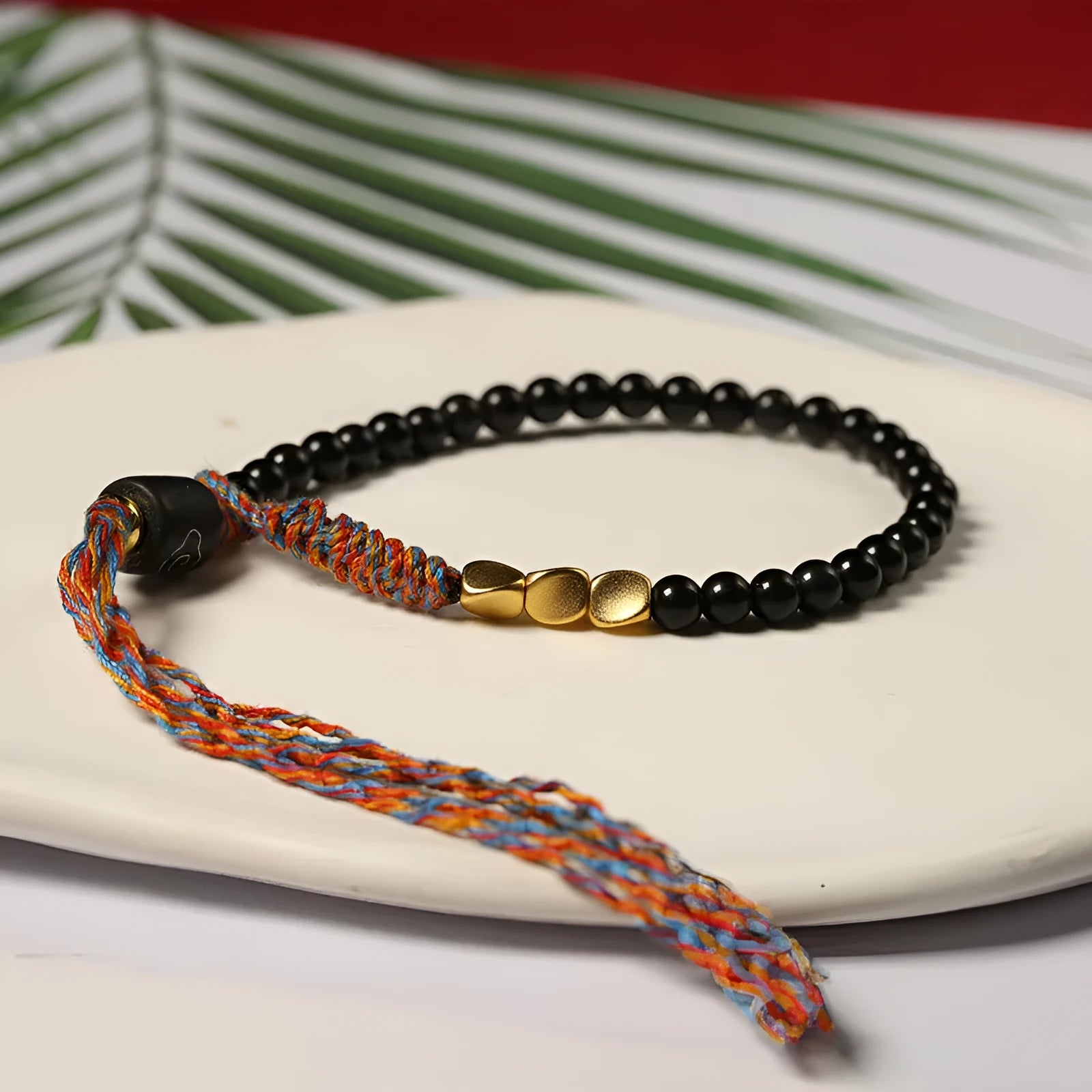 Hand-woven obsidian carrying strap bracelet with textured finish on wrist