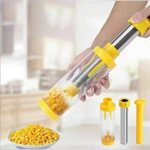 Yellow manual corn stripper thresher with stainless steel construction on a kitchen worktop.