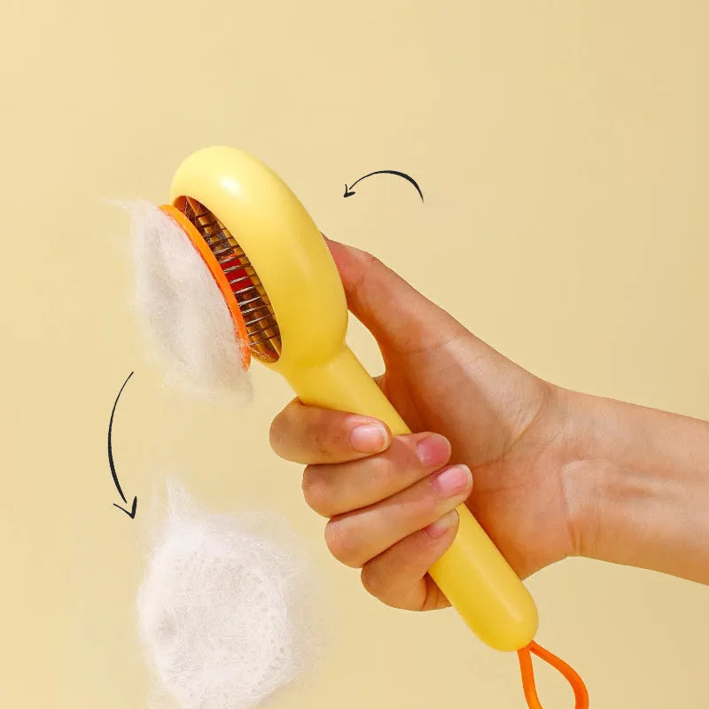 Small yellow duck-shaped pet grooming comb with open sections and needle teeth