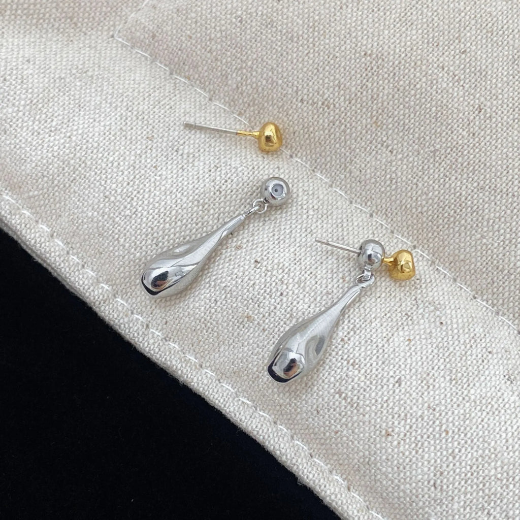 Water drop colour clash copper ear clips with teardrop and geometric shapes on women's ear