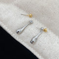Water drop colour clash copper ear clips with teardrop and geometric shapes on women's ear
