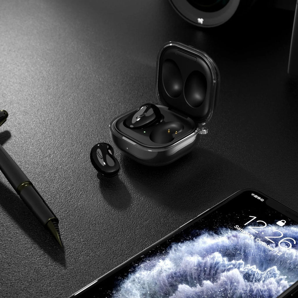 Transparent clamshell Bluetooth ear case in moulded plastic, available in translucent gold, black, and purple