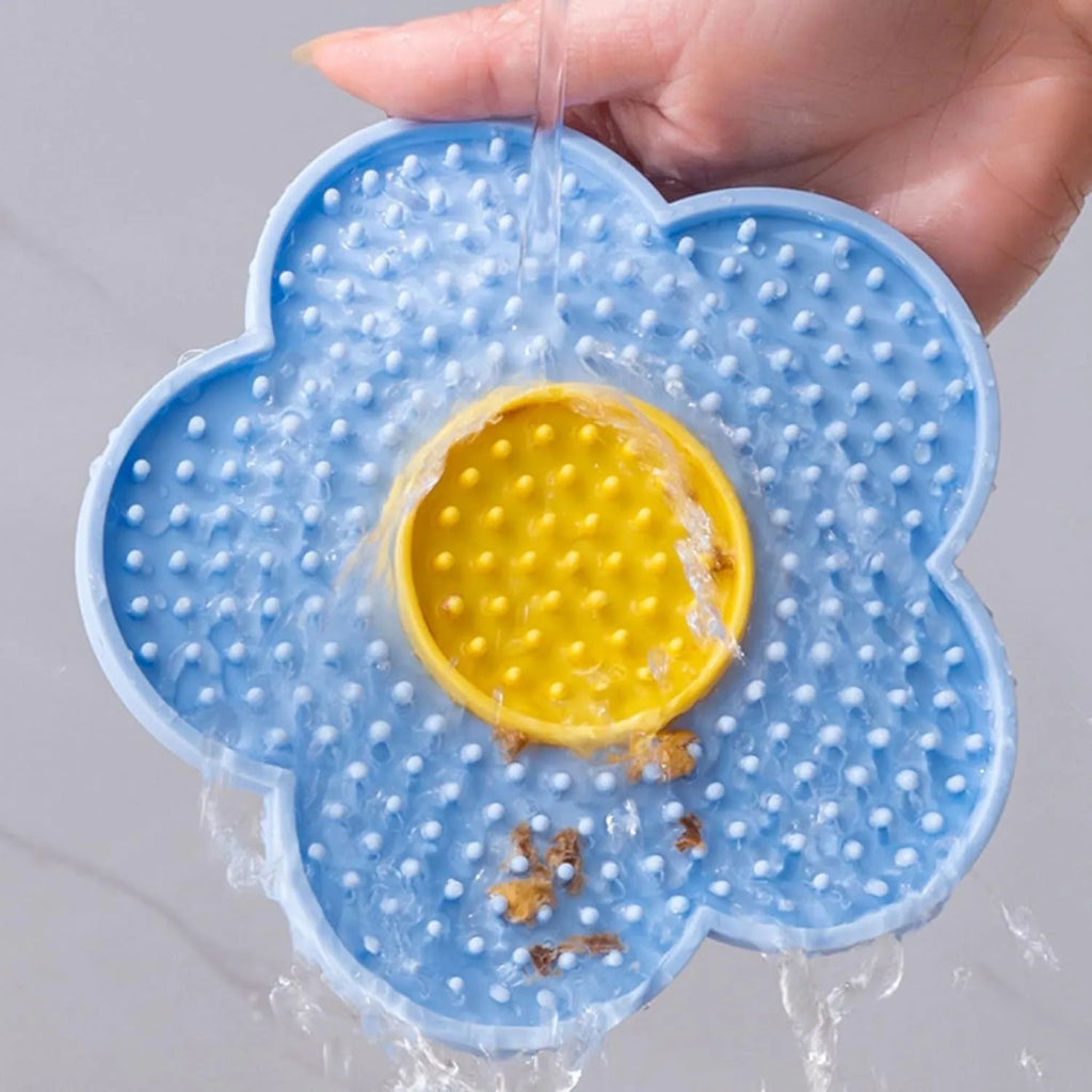 Flower-shaped silicone pet licking mat with suction cups in blue, grey, pink, purple, or red.