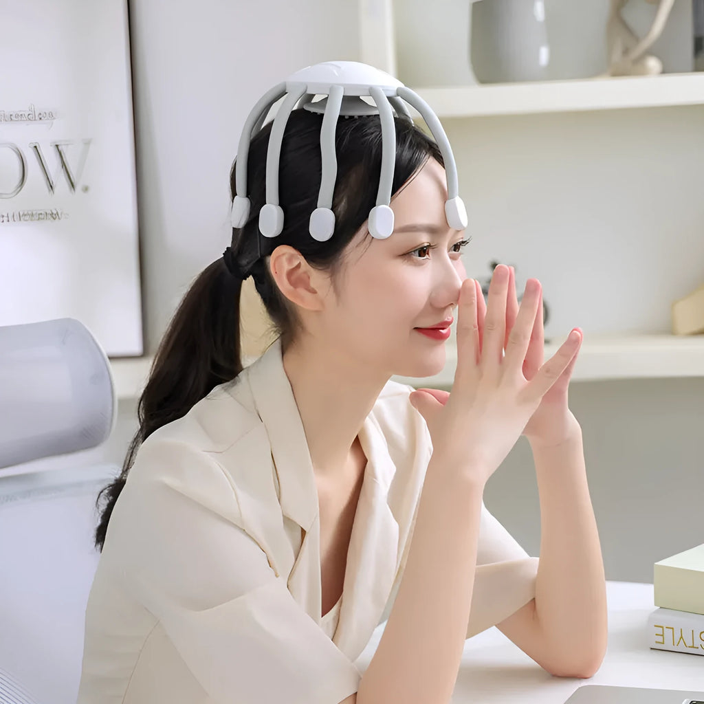 Black or white USB head massager with multiple claws for scalp vibration.