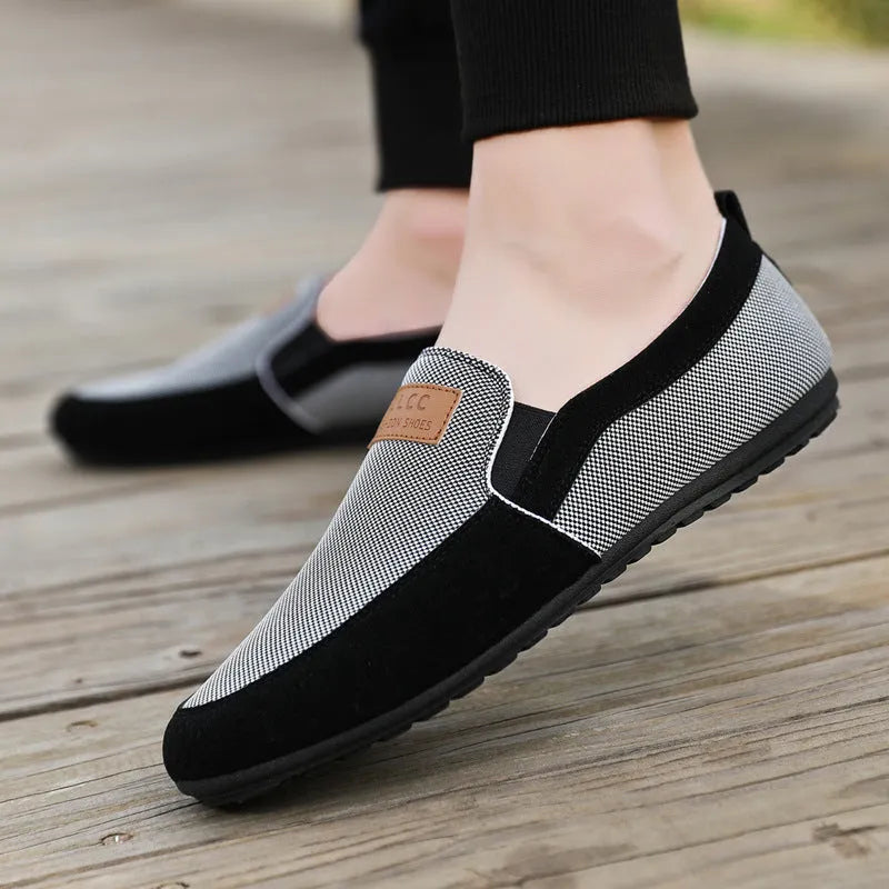 Men's grey canvas lace-up board shoes with round toe and rubber sole on a white background.