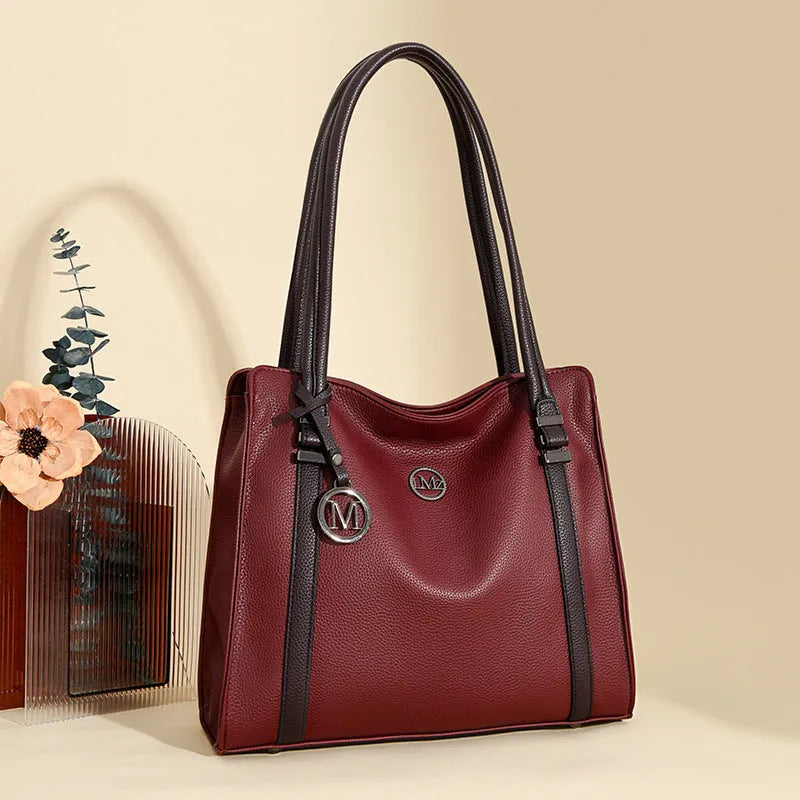 Women's large horizontal square crossbody bag in soft PU material, shown in wine red colour with double shoulder straps.