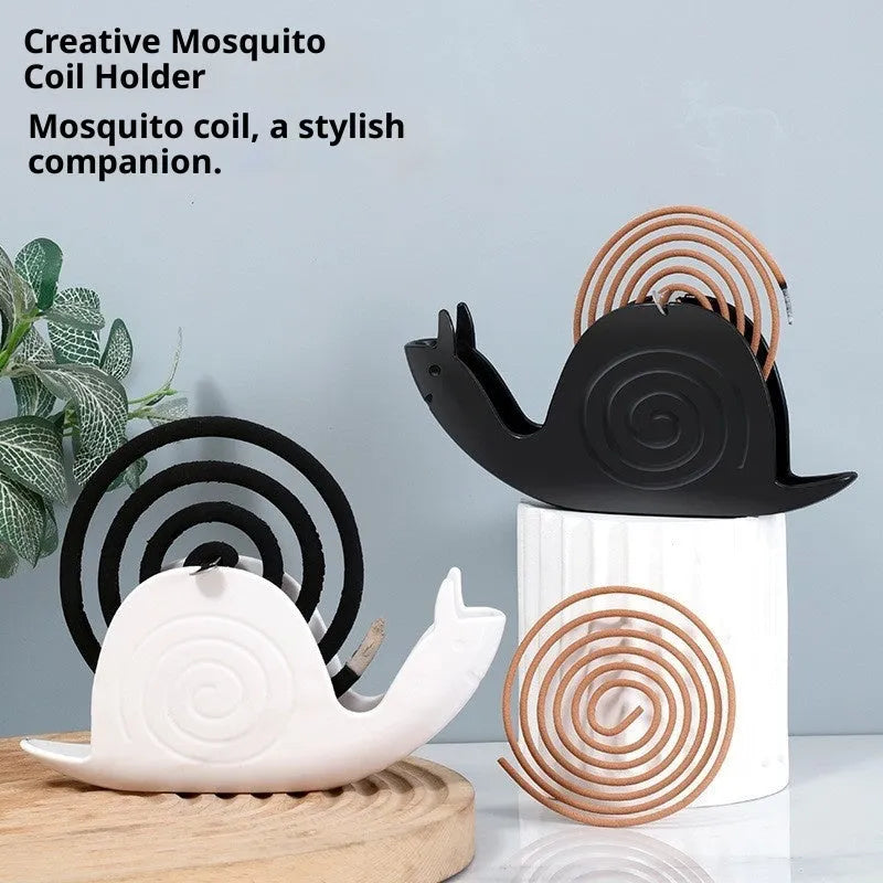 Black plastic mosquito incense holder with creative animal style on a flat surface