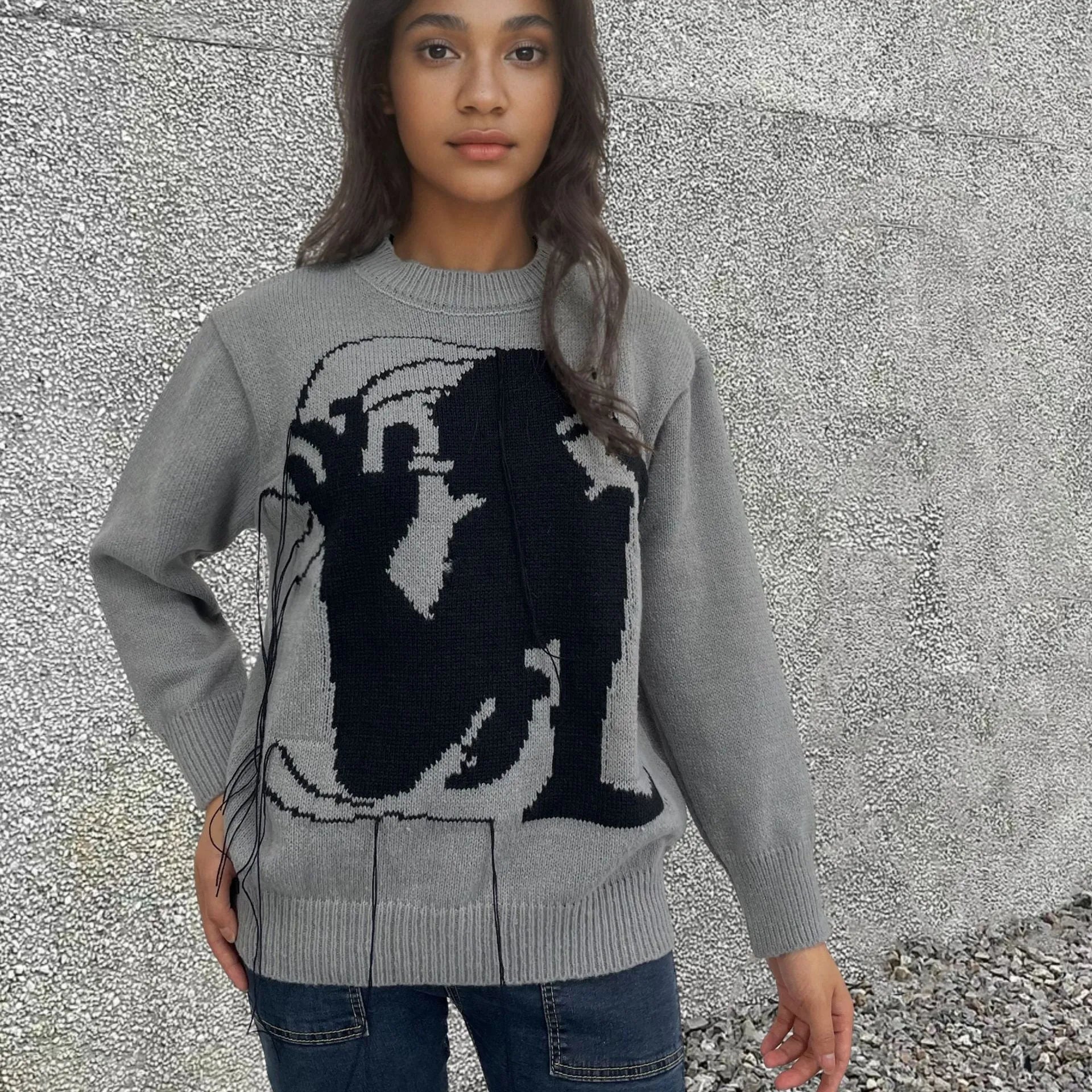 Grey and white women's alpaca wool sweater with tassel detail and abstract pattern.