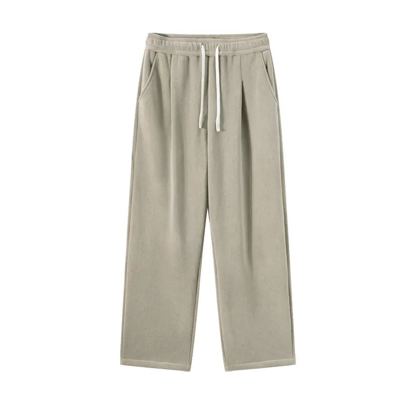 Men's apricot coloured loose-fit fleece-lined winter sports trousers with a drawstring waist laid flat.