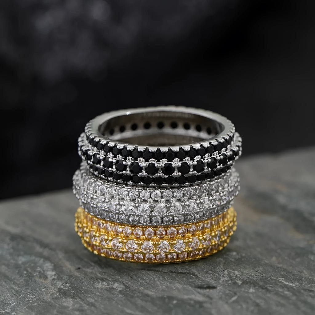 Geometric triangular ring with a zircon stone inlay, shown in white gold, yellow gold, and white and black finishes.