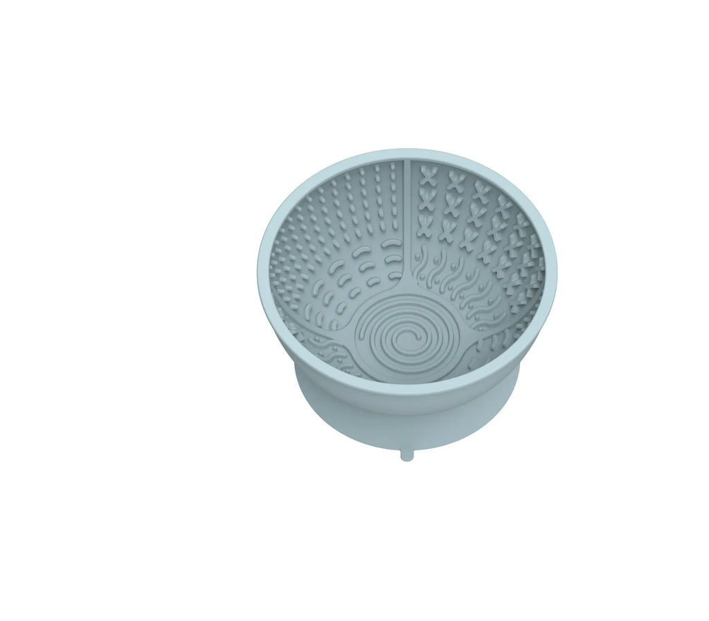 Cyan silicone pet bowl with textured licking mat surface and suction cup base for slow feeding