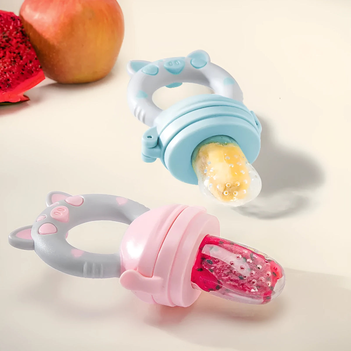 Silicone baby teether in blue, green, or pink colours with textured mouthpiece design