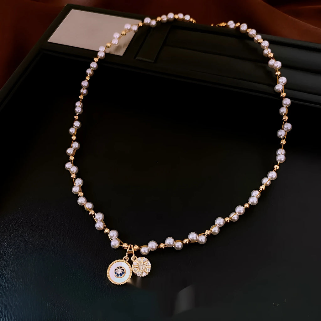 Golden-white electroplated necklace with round pearl pendant on adjustable clavicle chain
