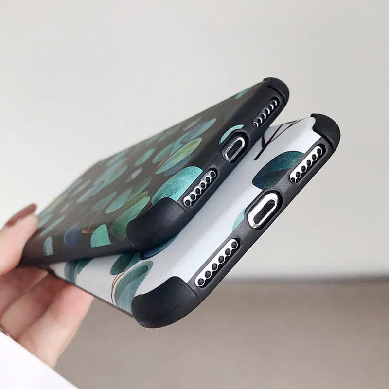 Black silicone iPhone case featuring a detailed leaf print design on the back.