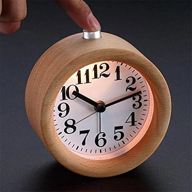 Solid beech wood silent snooze alarm clock with white dial and black numerals on a wooden surface.