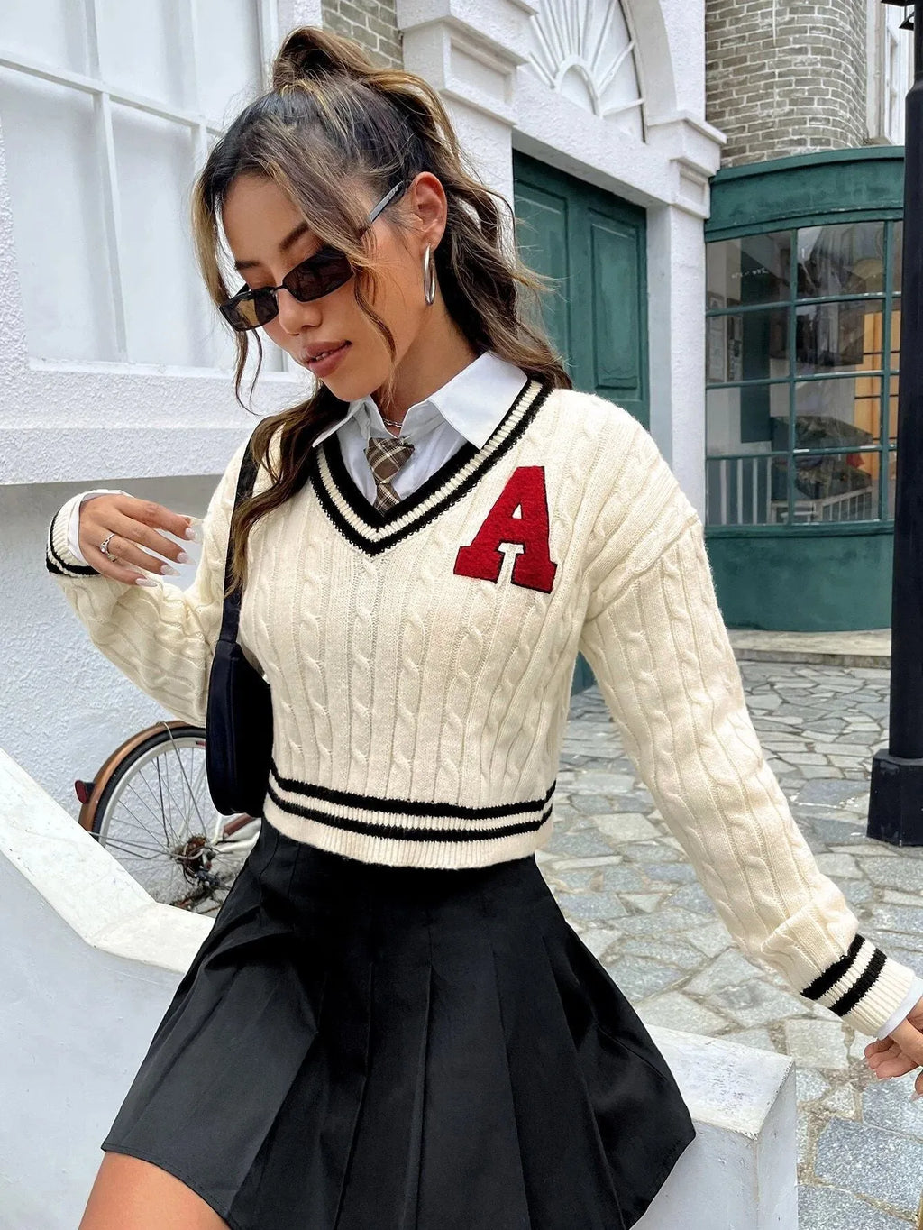 V-neck creamy white knitted shirt with slim stripes and patch detail on model