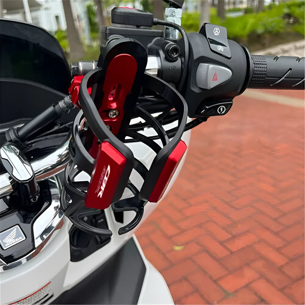 Black water bottle cage mounted on Honda X-ADV scooter modification