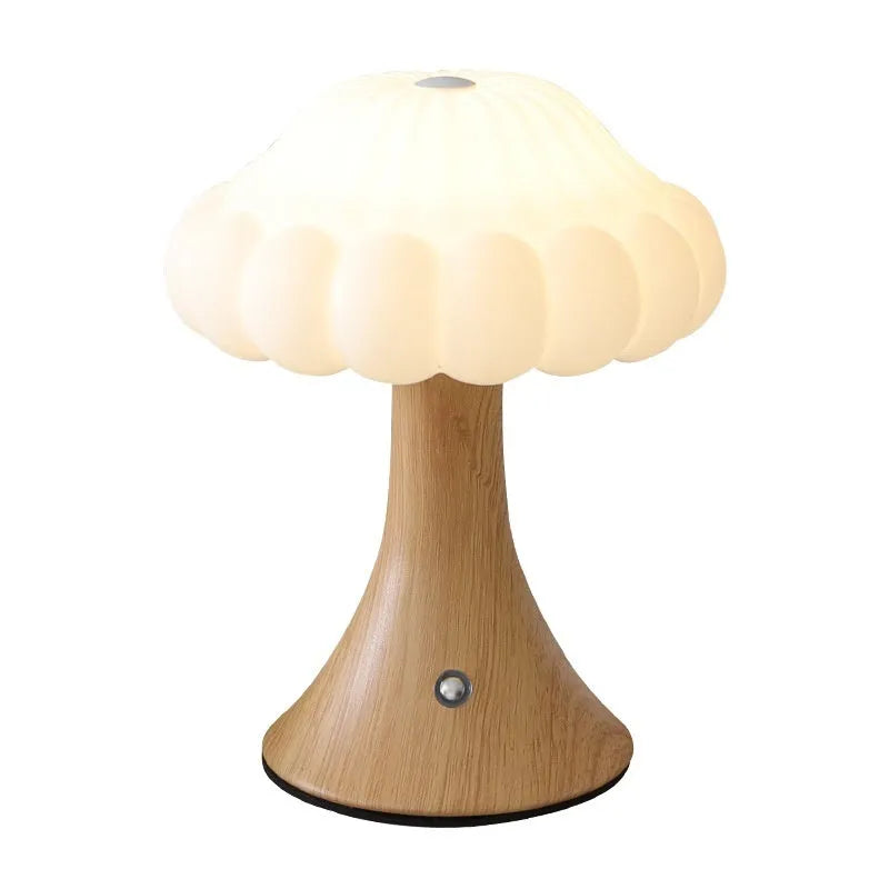 Small decorative mushroom-shaped night lamp on a surface, showcasing its USB charging port and touch control.