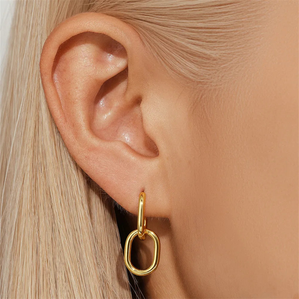 Golden brass diamond earclip earrings with simple geometric round design on white background