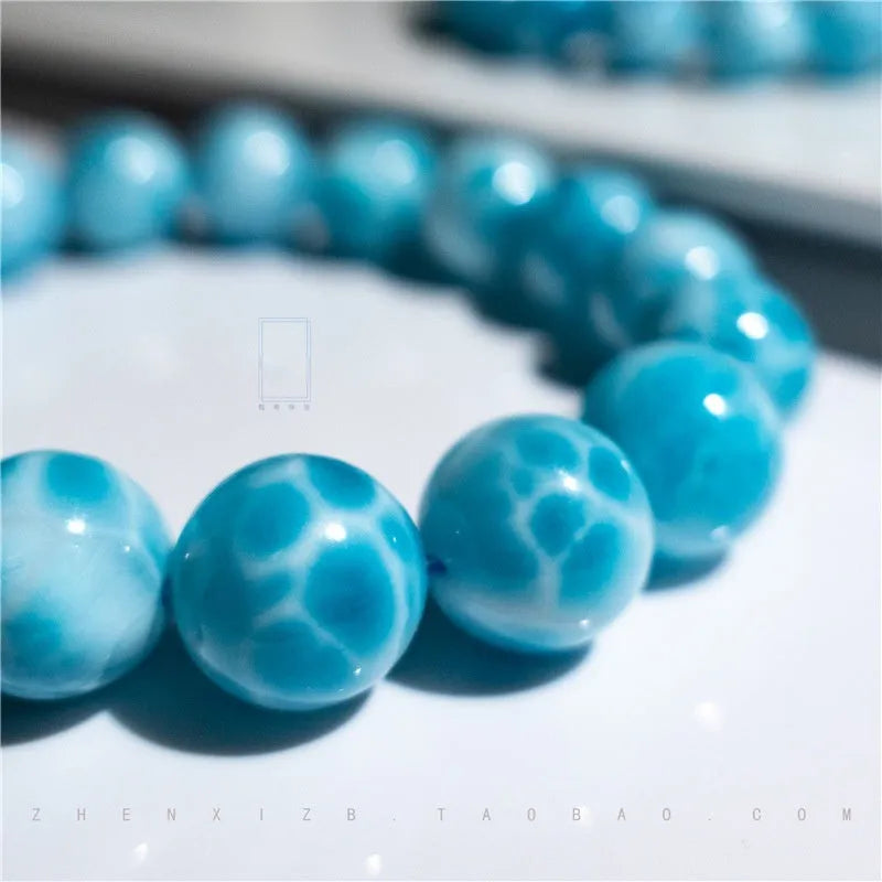 Blue Bodhi bracelet with pearl elements, showing Maillard style and range of bead sizes.