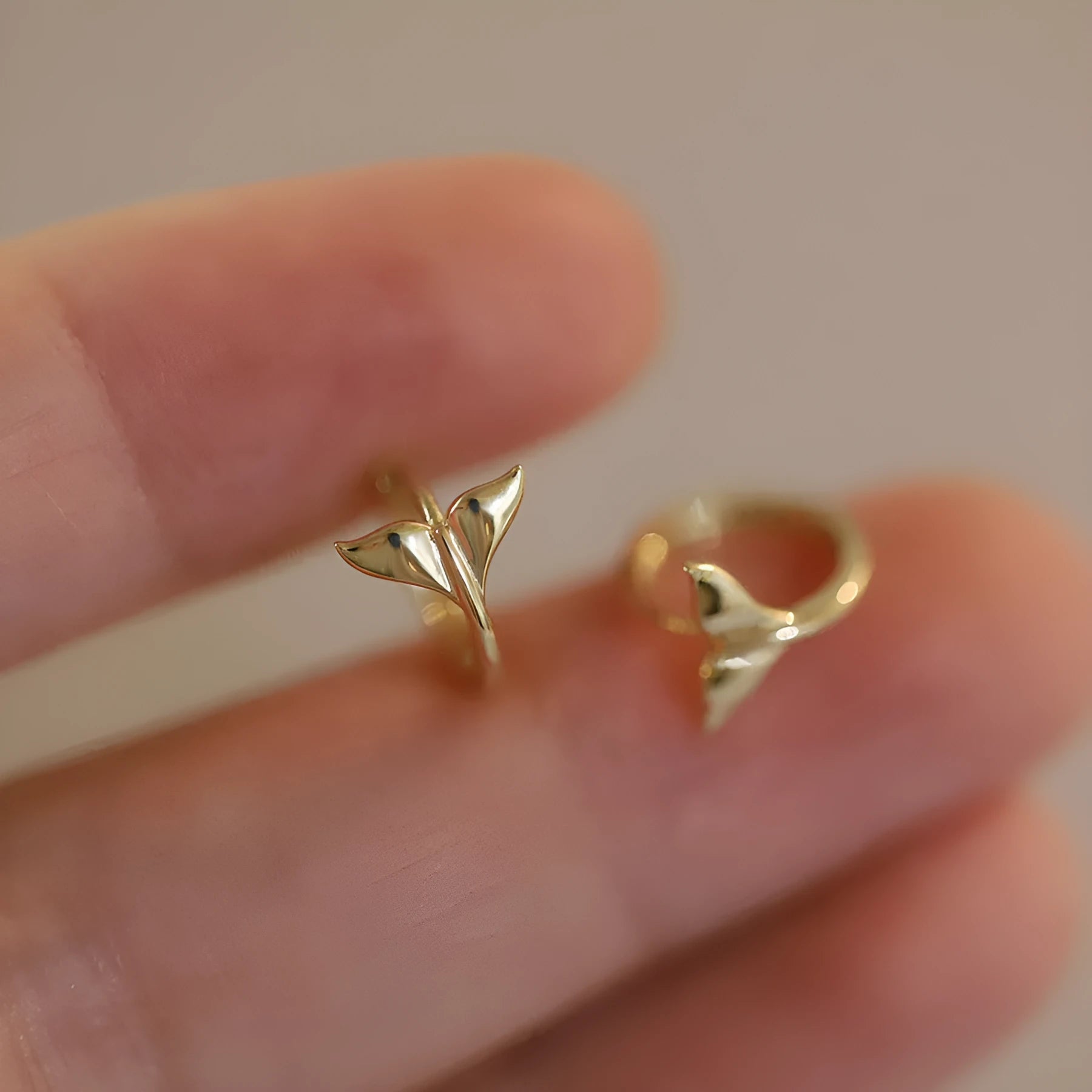 S925 sterling silver fishtail drop earrings in gold colour, showing smooth design and size.