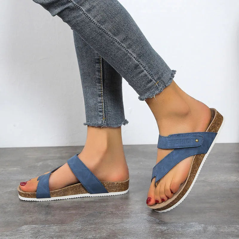 A pair of solid-colour flip-flops with a flat toe ring and thick foam sole.