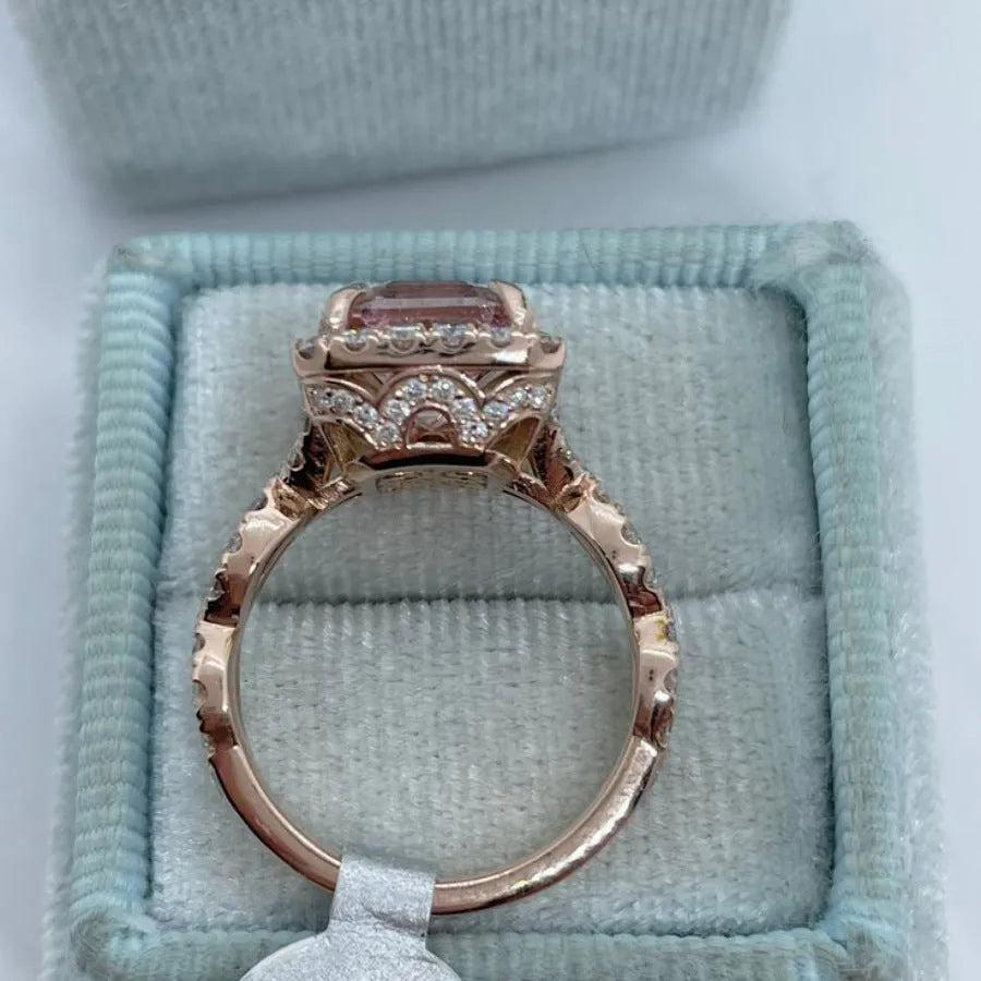 Rose gold geometric alloy ring on a plain background, showing its electroplated finish.