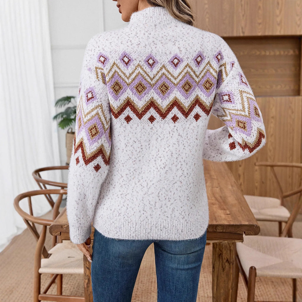 White geometric pattern half turtleneck loose fit long sleeve sweater on a hanger.