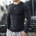 Man wearing black long sleeve slim fit sport tights for running or fitness
