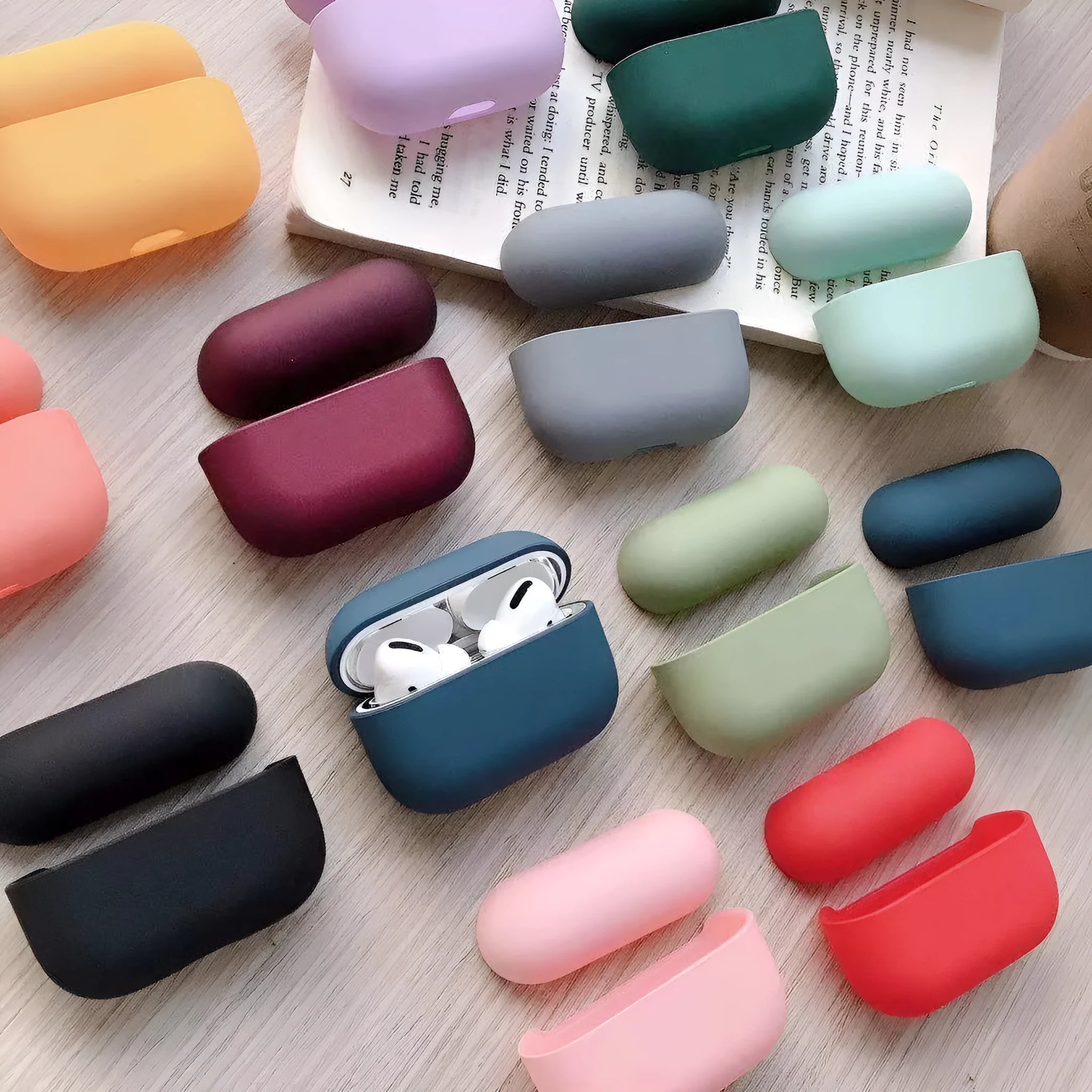 Plastic protective case for Apple AirPods Pro in various colours including black, pink, green, and blue.