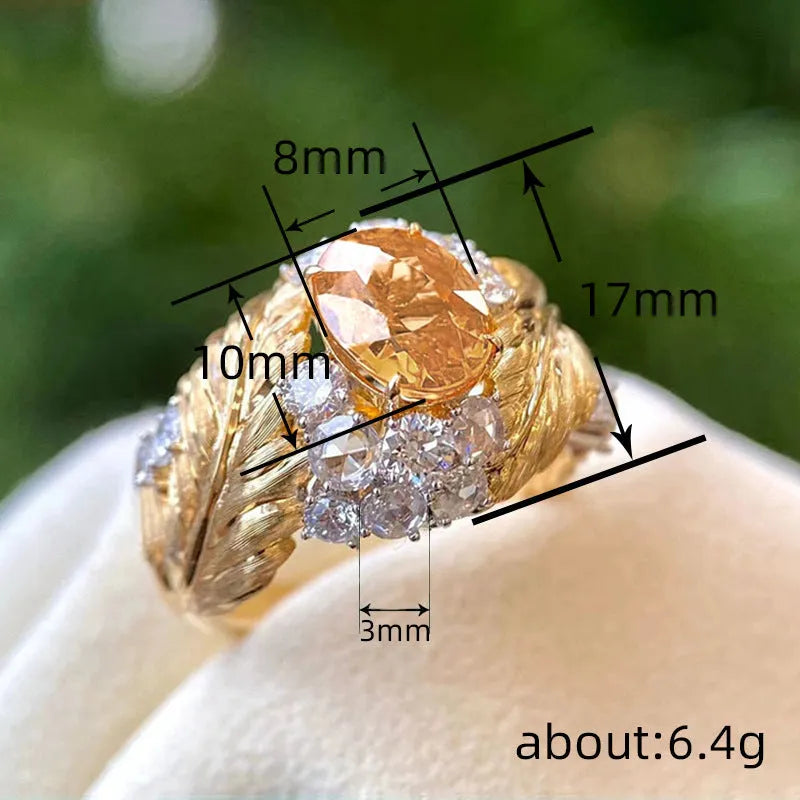 Copper feather embossed ring with yellow zircon stones, showing geometric design detail