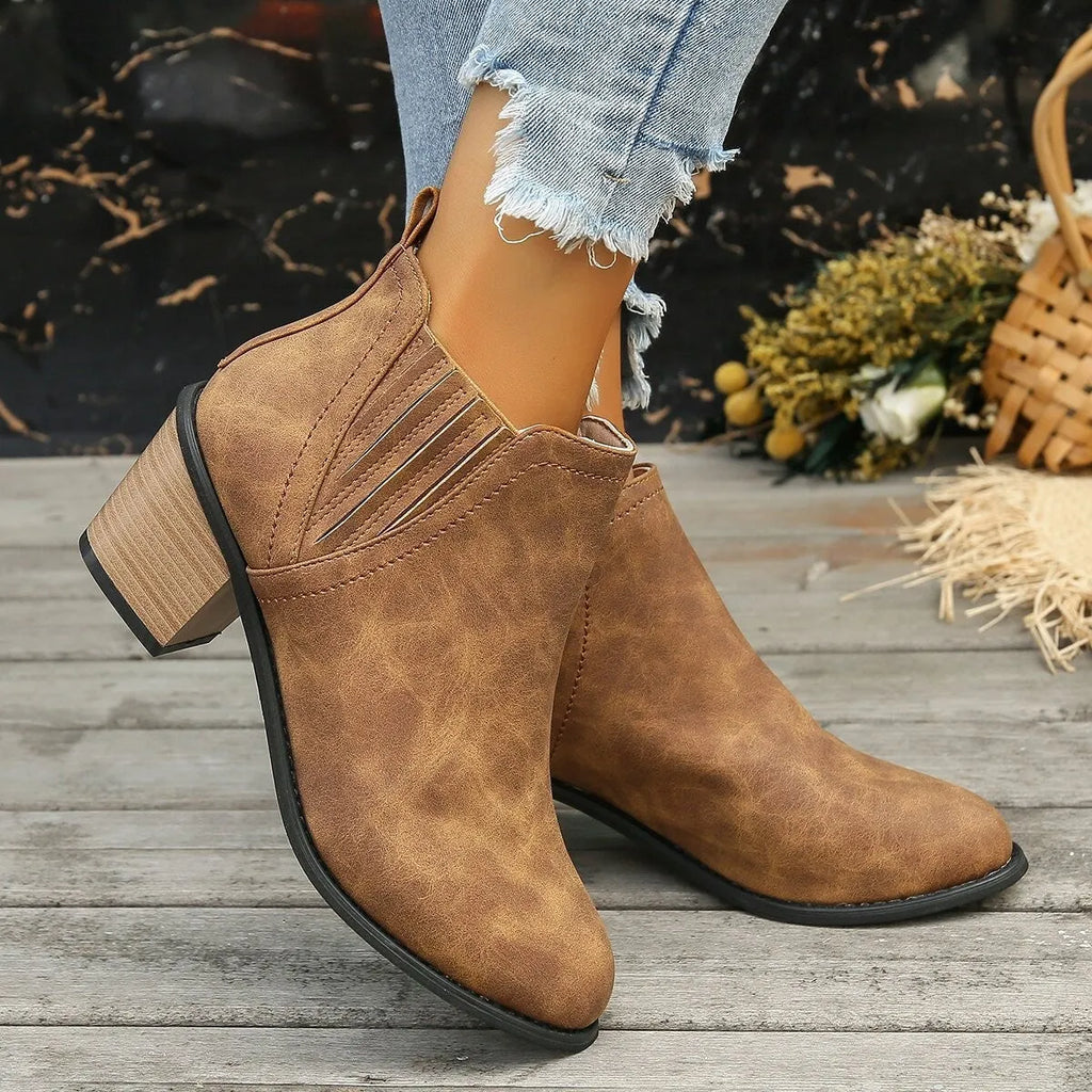 Women's black and brown pointed toe ankle boots with thick square heel and slip-on design made of artificial PU.