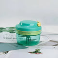Green manual baby food maker and garlic grinder with stainless steel blade, 300ml capacity.